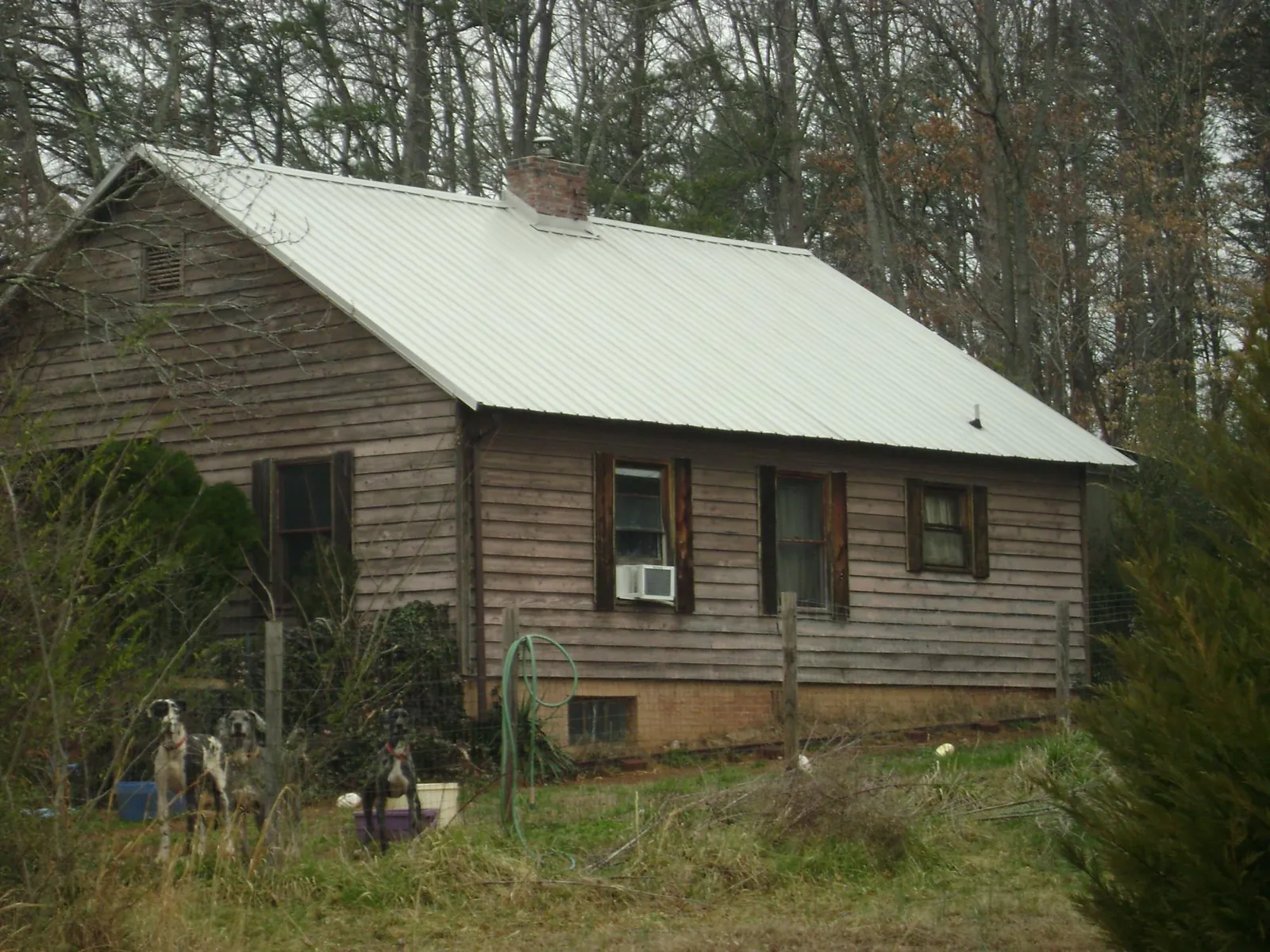White metal roof on an old wood sided farmhouse, from a Metal Roof Installation job in Barbourville
